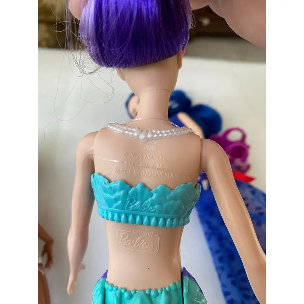 three dolls Barbie Dreamtopia Mermaid Doll with purple hair and purple-and blue